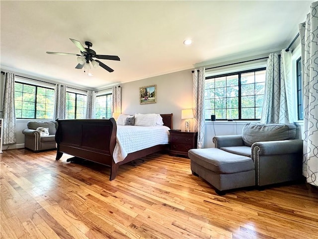 bedroom featuring ornamental molding, light wood finished floors, a ceiling fan, and recessed lighting
