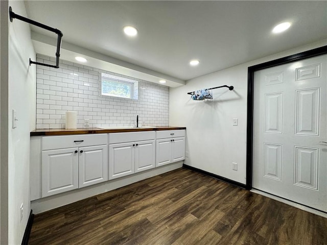 laundry room with dark wood-type flooring, recessed lighting, and baseboards