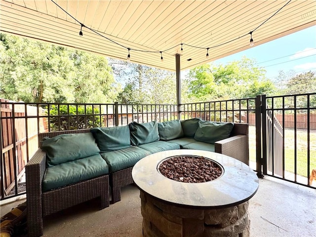 balcony with an outdoor living space with a fire pit and a patio