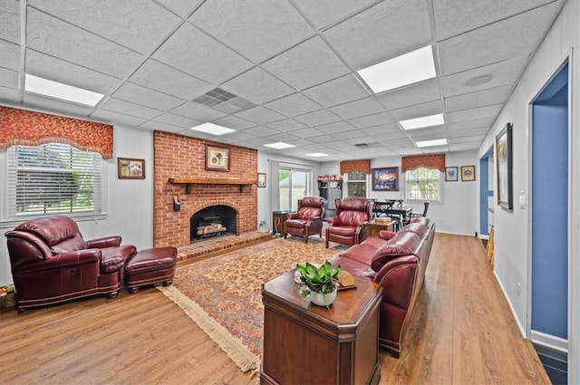 224 Sheffield Rd, Greer, SC 29651 - living room featuring light wood-style floors, a drop ceiling, and a brick fireplace