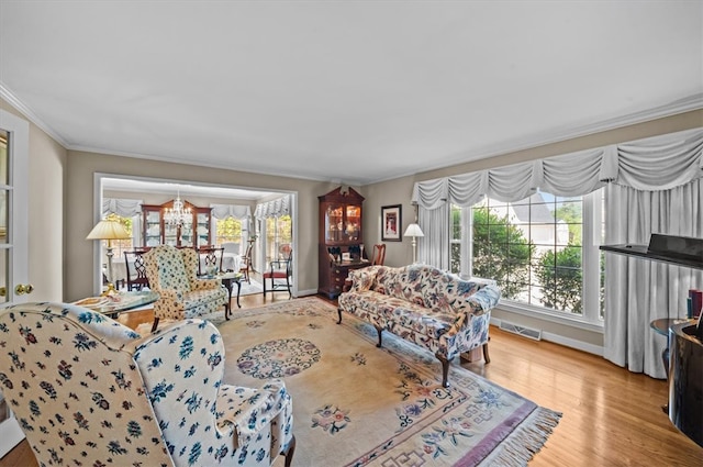 224 Sheffield Rd, Greer, SC 29651 - living room with plenty of natural light, a chandelier, ornamental molding, wood finished floors, and baseboards