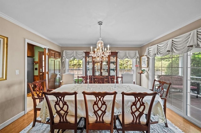 224 Sheffield Rd, Greer, SC 29651 - dining area featuring a chandelier, crown molding, healthy amount of natural light, light wood finished floors, and baseboards