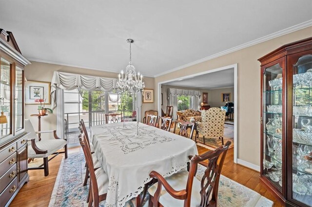 224 Sheffield Rd, Greer, SC 29651 - dining room featuring a chandelier, ornamental molding, light wood-style floors, and baseboards