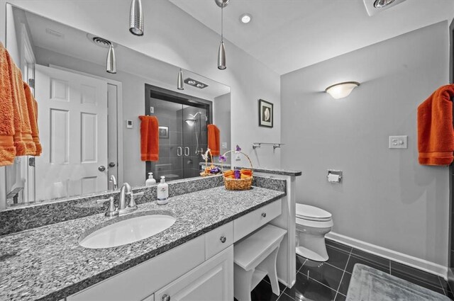 224 Sheffield Rd, Greer, SC 29651 - bathroom featuring a stall shower, toilet, baseboards, vanity, and tile patterned flooring