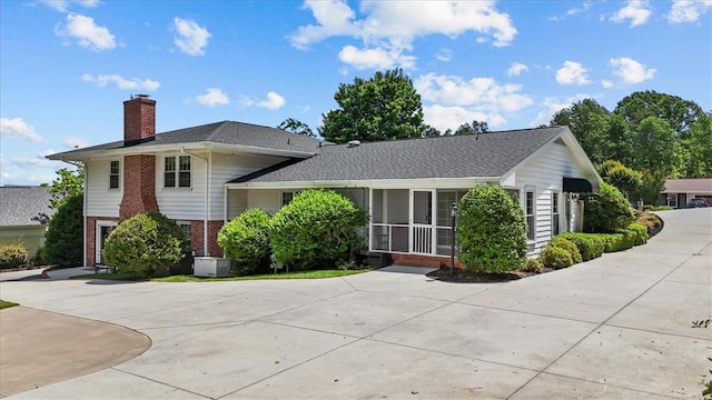 224 Sheffield Rd, Greer, SC 29651 - split level home with brick siding, a chimney, central AC unit, and driveway