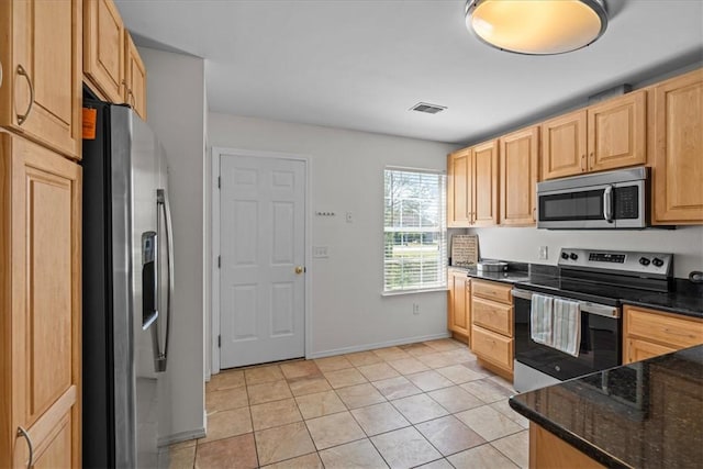 105 Tripmont Ct, Simpsonville, SC 29680 - kitchen with stainless steel appliances, light brown cabinets, light tile patterned floors, dark stone counters, and baseboards