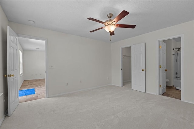 105 Tripmont Ct, Simpsonville, SC 29680 - unfurnished bedroom with carpet flooring, a spacious closet, baseboards, ceiling fan, and connected bathroom