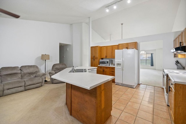 111 Coachman Ct, Anderson, SC 29625 - kitchen featuring white appliances, light carpet, brown cabinetry, open floor plan, and high vaulted ceiling