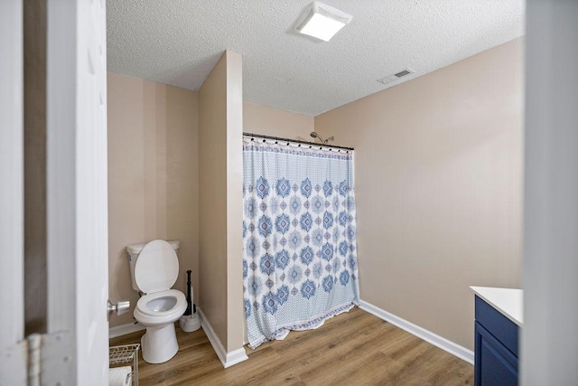 111 Coachman Ct, Anderson, SC 29625 - bathroom with wood finished floors, a shower with shower curtain, a textured ceiling, toilet, and vanity