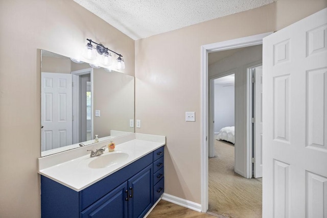 111 Coachman Ct, Anderson, SC 29625 - bathroom with a textured ceiling, vanity, baseboards, and wood finished floors