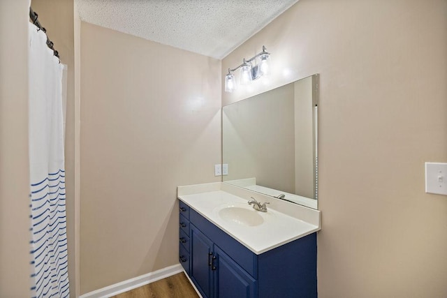 111 Coachman Ct, Anderson, SC 29625 - bathroom featuring a textured ceiling, vanity, wood finished floors, and baseboards