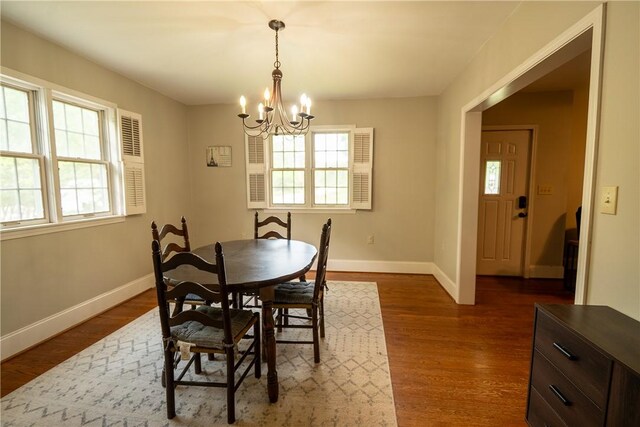 dining area with a chandelier, healthy amount of natural light, and baseboards