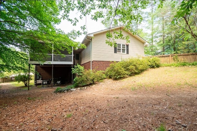 rear view of house featuring fence
