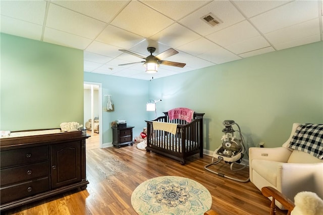 100 Berkeley Ct, Clemson, SC 29631 - bedroom with a drop ceiling, wood finished floors, a ceiling fan, a crib, and baseboards