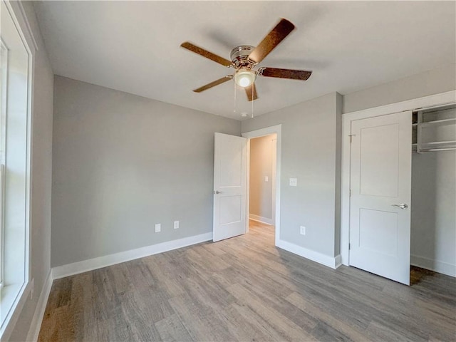 324 Code Cir, Seneca, SC 29678 - unfurnished bedroom with wood finished floors, a closet, baseboards, and a ceiling fan
