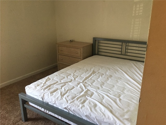 carpeted bedroom featuring baseboards