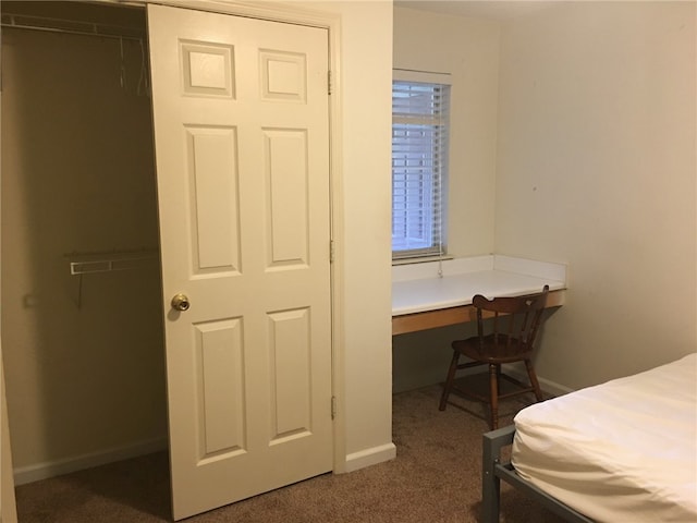 carpeted bedroom featuring baseboards