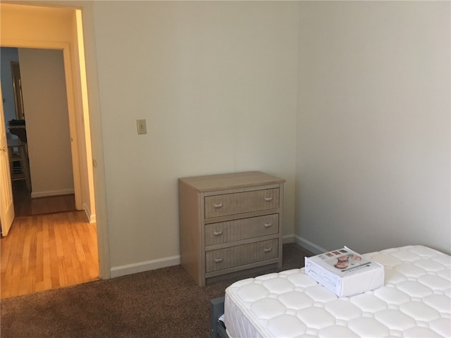 carpeted bedroom featuring baseboards