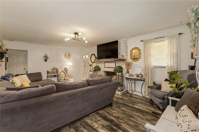 203 Greenmeadow Cir, Anderson, SC 29626 - living room featuring dark wood finished floors, ornamental molding, a brick fireplace, and a chandelier