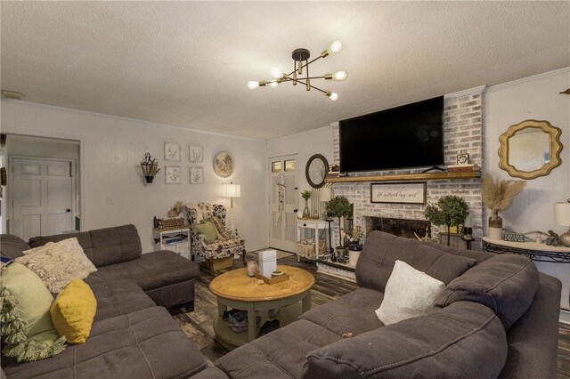 203 Greenmeadow Cir, Anderson, SC 29626 - living room with a chandelier, ornamental molding, wood finished floors, a textured ceiling, and a fireplace