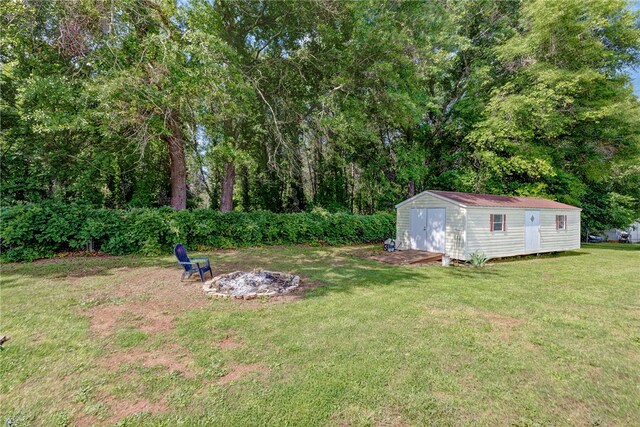 203 Greenmeadow Cir, Anderson, SC 29626 - view of green lawn with an outdoor fire pit, an outdoor structure, and a storage shed