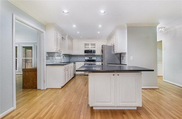 503 Columbine Ct, Easley, SC 29642 - kitchen with stainless steel appliances, a sink, white cabinetry, backsplash, and light wood-type flooring