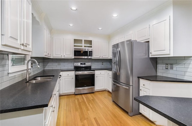 503 Columbine Ct, Easley, SC 29642 - kitchen featuring appliances with stainless steel finishes, a sink, white cabinetry, recessed lighting, and crown molding