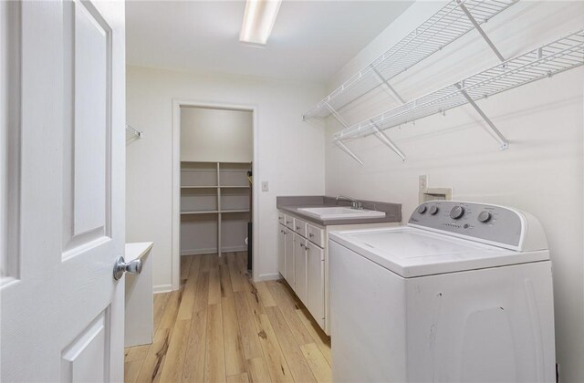 503 Columbine Ct, Easley, SC 29642 - clothes washing area with washer / clothes dryer, cabinet space, light wood-style flooring, and baseboards