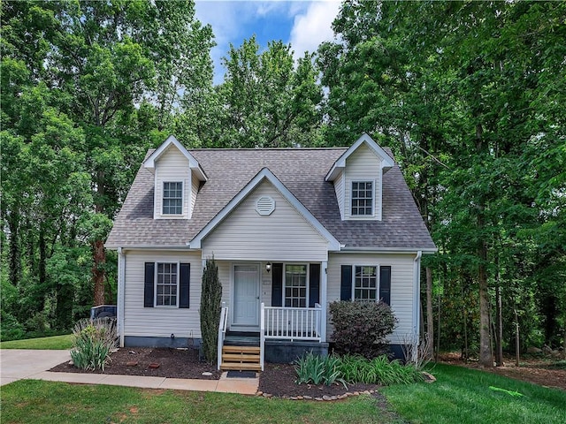 205 Washington Ave, Easley, SC 29640 - cape cod-style house with covered porch, a front lawn, and a shingled roof