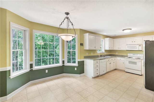 205 Washington Ave, Easley, SC 29640 - kitchen featuring white appliances, a sink, white cabinetry, and baseboards