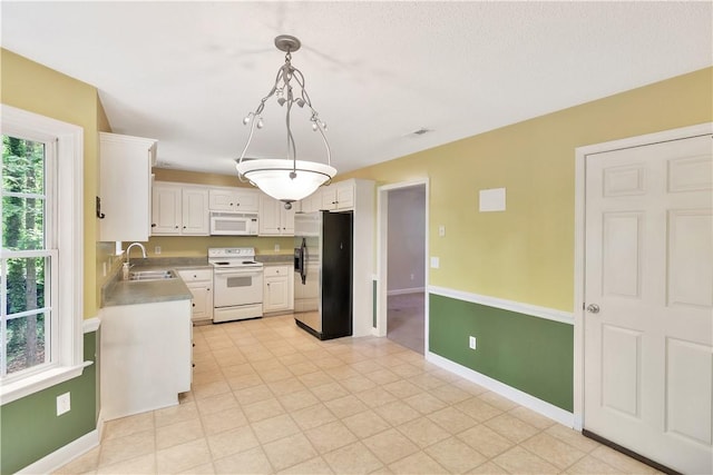 205 Washington Ave, Easley, SC 29640 - kitchen featuring white appliances, a sink, white cabinets, baseboards, and light countertops