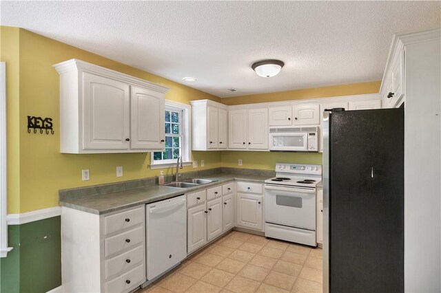 205 Washington Ave, Easley, SC 29640 - kitchen featuring white appliances, a sink, white cabinets, a textured ceiling, and dark countertops
