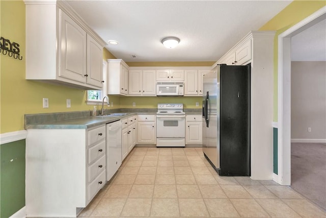 205 Washington Ave, Easley, SC 29640 - kitchen featuring white appliances, a sink, white cabinetry, light tile patterned floors, and baseboards