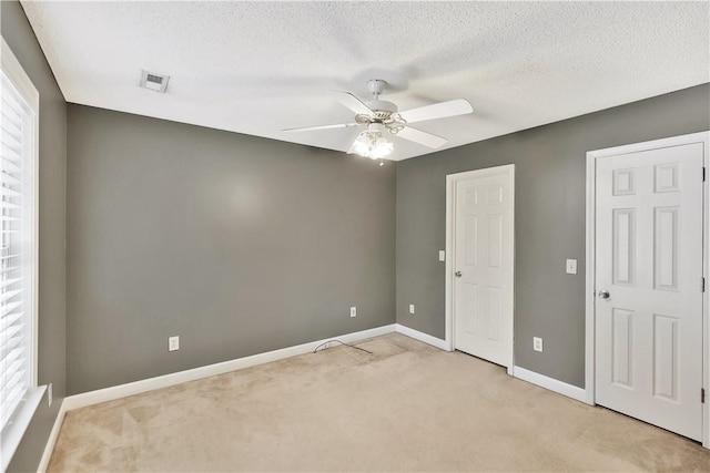 205 Washington Ave, Easley, SC 29640 - spare room with light colored carpet, ceiling fan, baseboards, and a textured ceiling