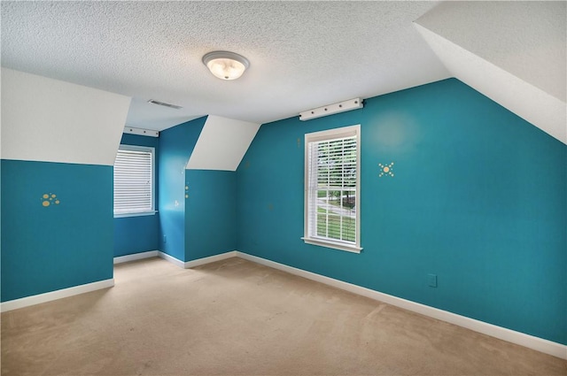 205 Washington Ave, Easley, SC 29640 - bonus room with lofted ceiling, carpet, baseboards, and a textured ceiling