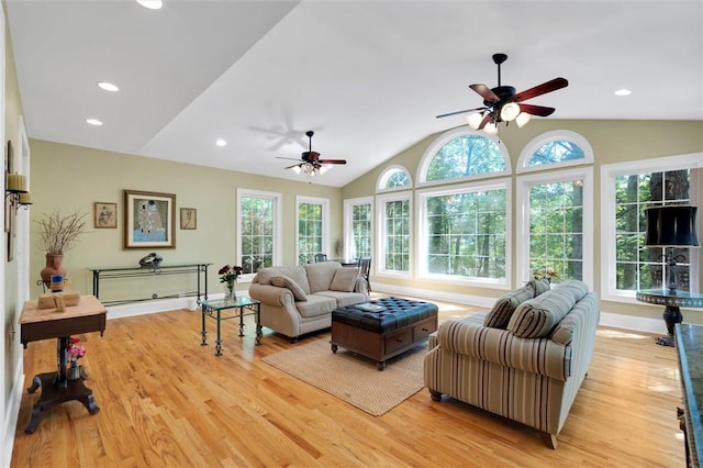 living area with a ceiling fan, vaulted ceiling, light wood-style flooring, baseboards, and recessed lighting