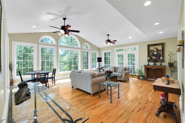 living area with light wood-style flooring, ceiling fan, vaulted ceiling, and recessed lighting