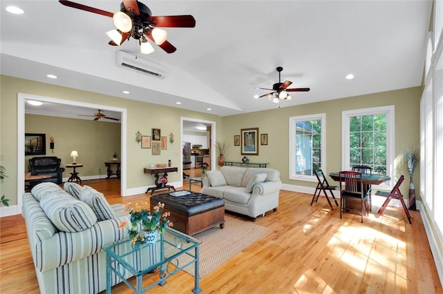 living area with ceiling fan, vaulted ceiling, light wood-type flooring, recessed lighting, and baseboards