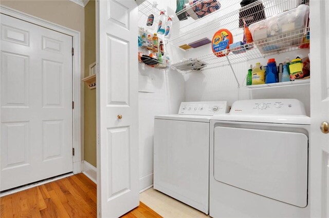 washroom featuring separate washer and dryer and light wood-style floors