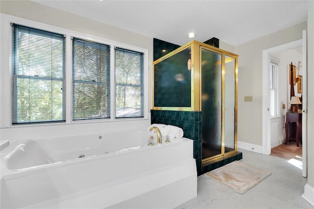 full bathroom with a jetted tub, a stall shower, and marble finish floors