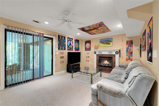 living area featuring a ceiling fan, recessed lighting, carpet, a tile fireplace, and baseboards