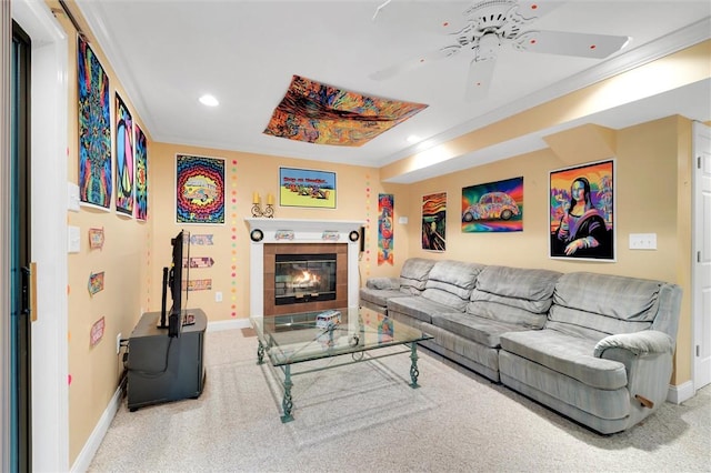 carpeted living room featuring a ceiling fan, crown molding, baseboards, recessed lighting, and a tiled fireplace