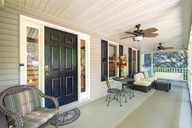 sunroom / solarium featuring healthy amount of natural light and ceiling fan