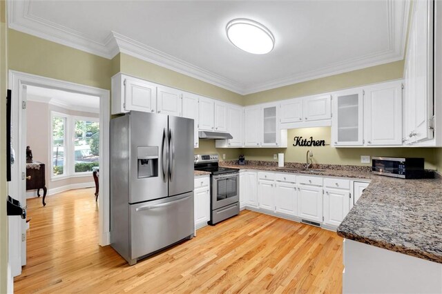 kitchen with stainless steel appliances, under cabinet range hood, ornamental molding, light wood-type flooring, and white cabinets