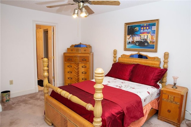 bedroom featuring light carpet, baseboards, and a ceiling fan