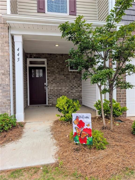 entrance to property featuring brick siding