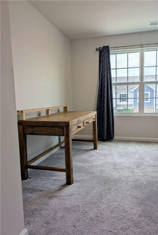 unfurnished office with carpet flooring and baseboards
