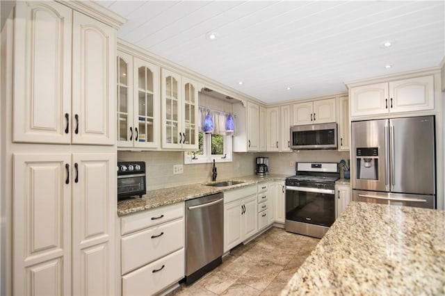 32 Par Harbor Way, Salem, SC 29676 - kitchen featuring appliances with stainless steel finishes, cream cabinetry, a sink, light stone countertops, and recessed lighting