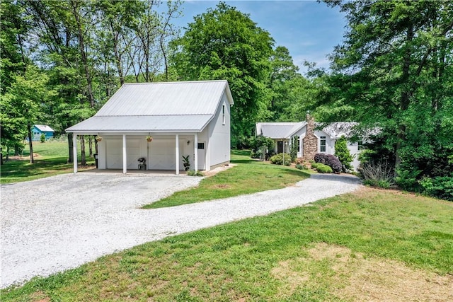 224 Edgewood Dr, Seneca, SC 29678 - view of front facade with a front lawn, a detached garage, an outbuilding, a metal roof, and driveway