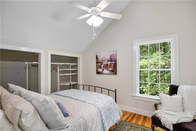 224 Edgewood Dr, Seneca, SC 29678 - bedroom featuring multiple closets, wood finished floors, high vaulted ceiling, and a ceiling fan